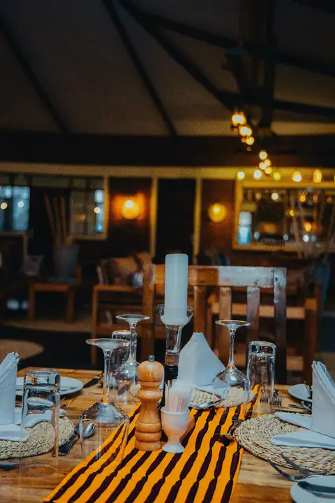 Candlelit table setting with a striped runner
