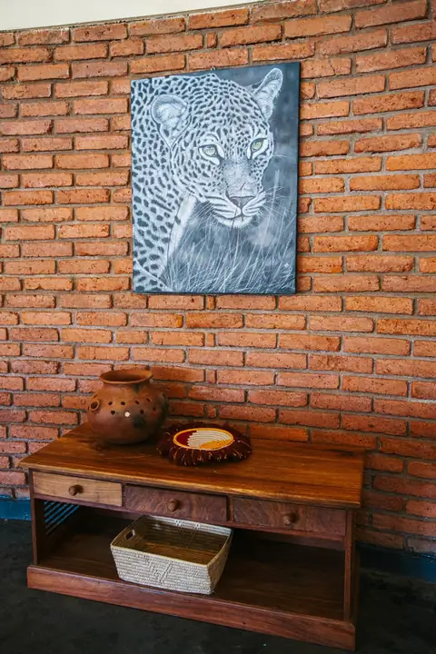 Leopard artwork on a brick wall