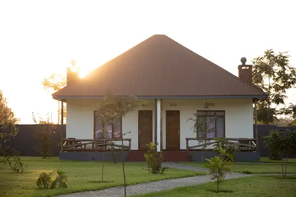 A villa with its veranda and chimney at sunset